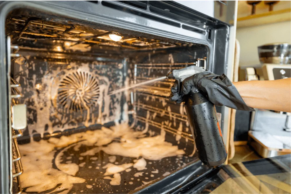 Cleaning product being sprayed in a large oven.